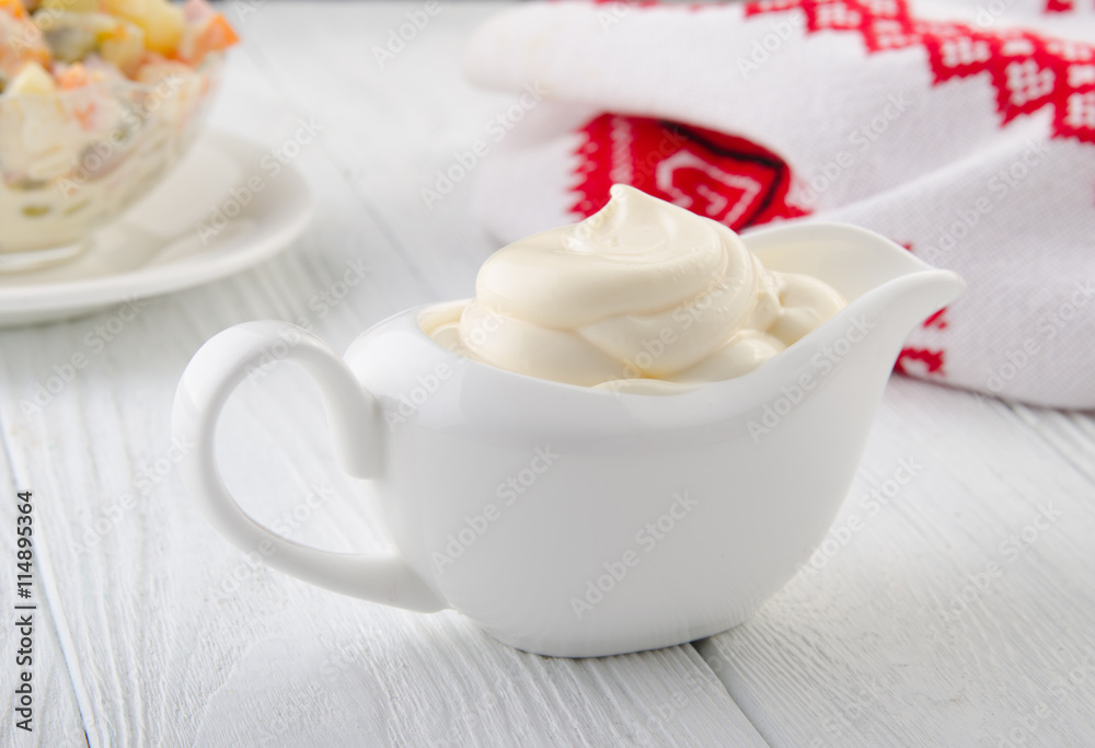Mayonnaise on a wooden table. Russian style