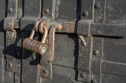 Old rusty padlock on the bolt