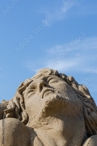 TAIPEI, TAIWAN - July 2, 2016: Fulong International Sand Sculpture Arts Festival at Fulong beach. Man's face sculpture. photo