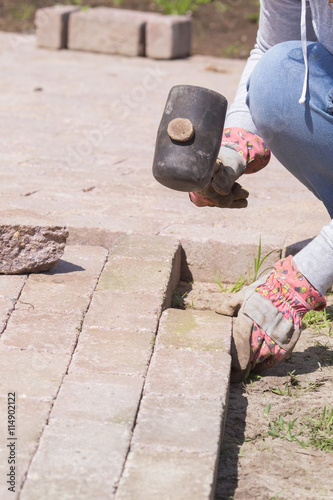 A woman is laying a pavement photo