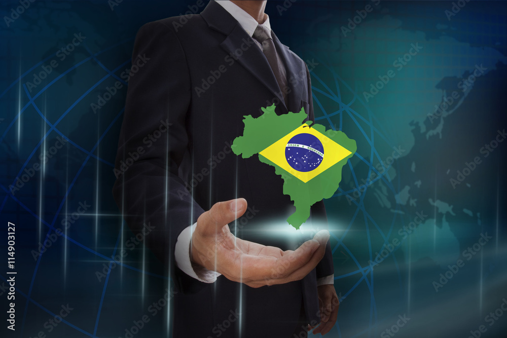 Businessman showing map of Brazil on globe background