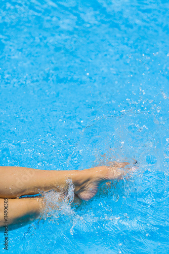 Sexy women legs splashing in swimming pool © Netfalls