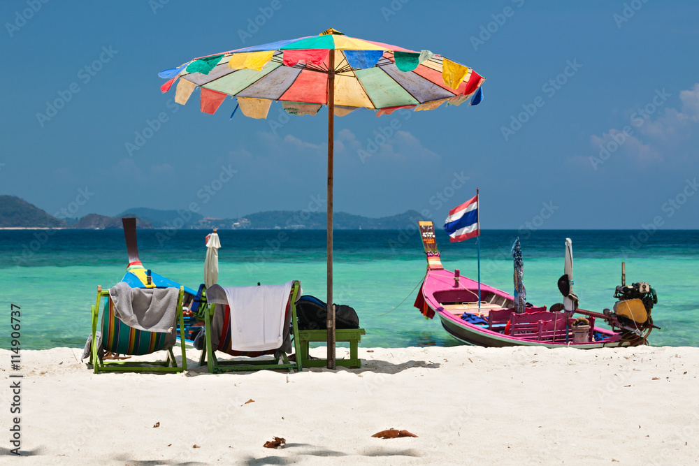 Beach umbrella and chairs in Coral island, Thailand