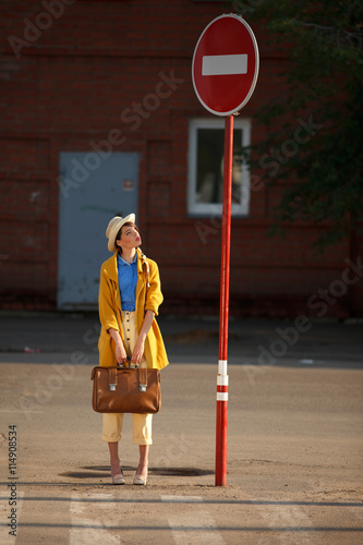 Young happy woman with retro suitcase