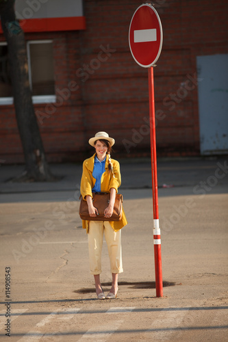 Young happy woman with retro suitcase. 