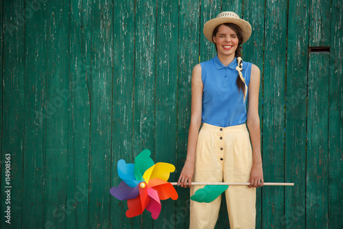 Young happy funny dressed woman with colorful weather vane © furmananna