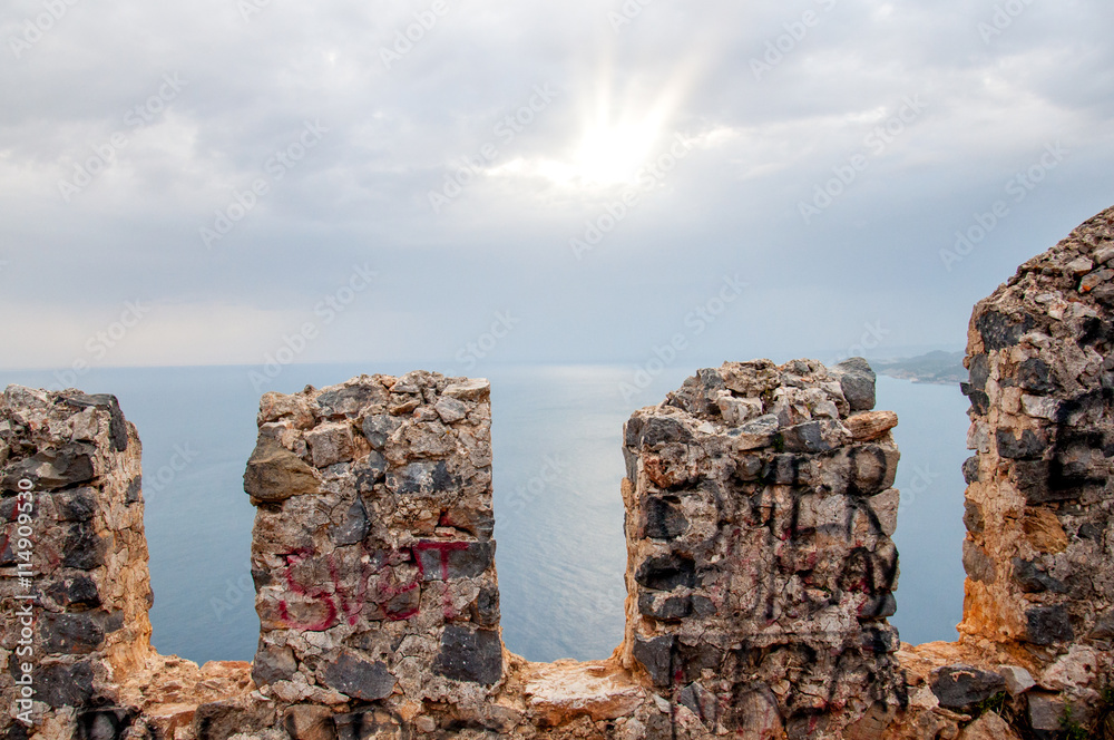 View through castle wall on sea sunset