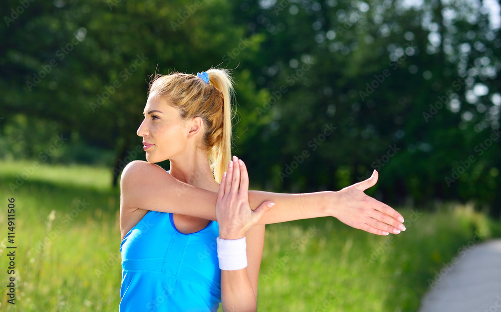 attractive and sporty young woman stretching outdoors attractive and sporty young woman stretching outdoors