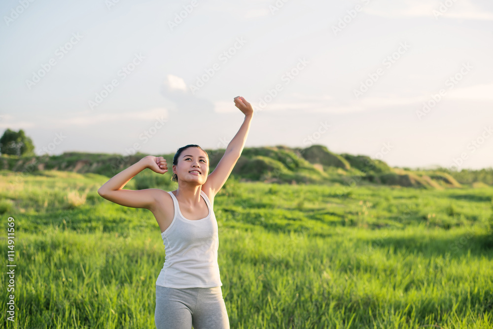 Happy beautiful woman with stretched arms in meadows with fresh Happy beautiful woman with stretched arms in meadows with fresh
