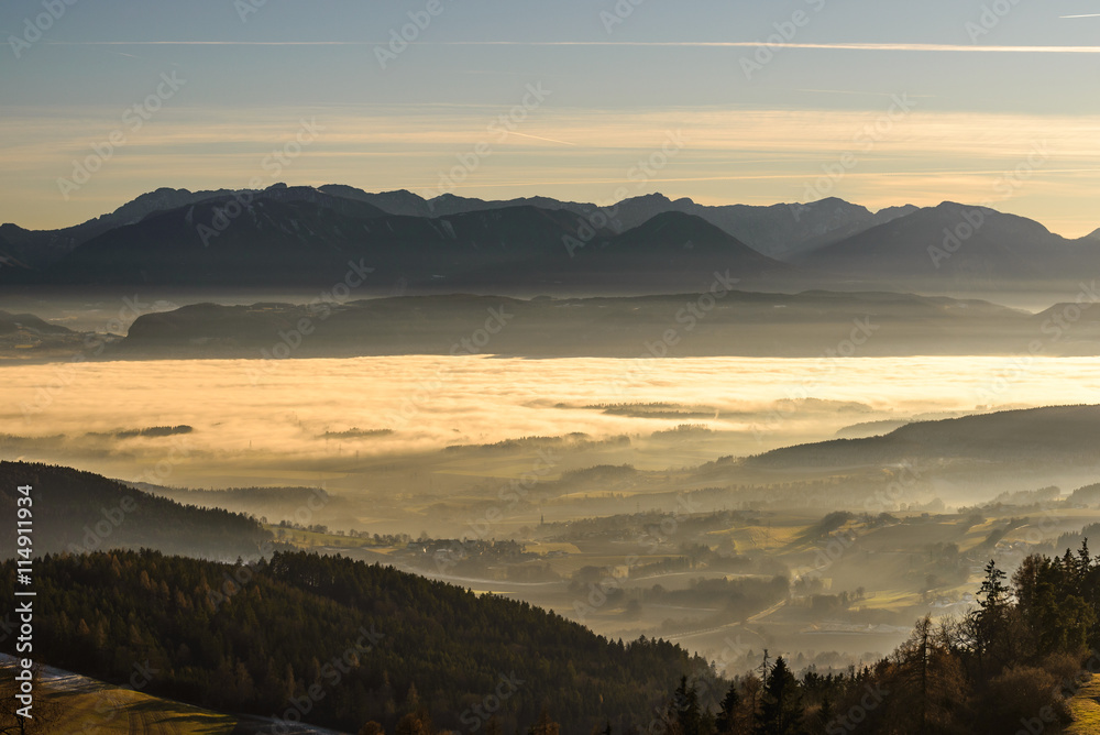 Beautiful sunset in mountains with fog in valleys.Carinthia, Austria. Beautiful sunset in mountains with fog in valleys.Carinthia, Austria.