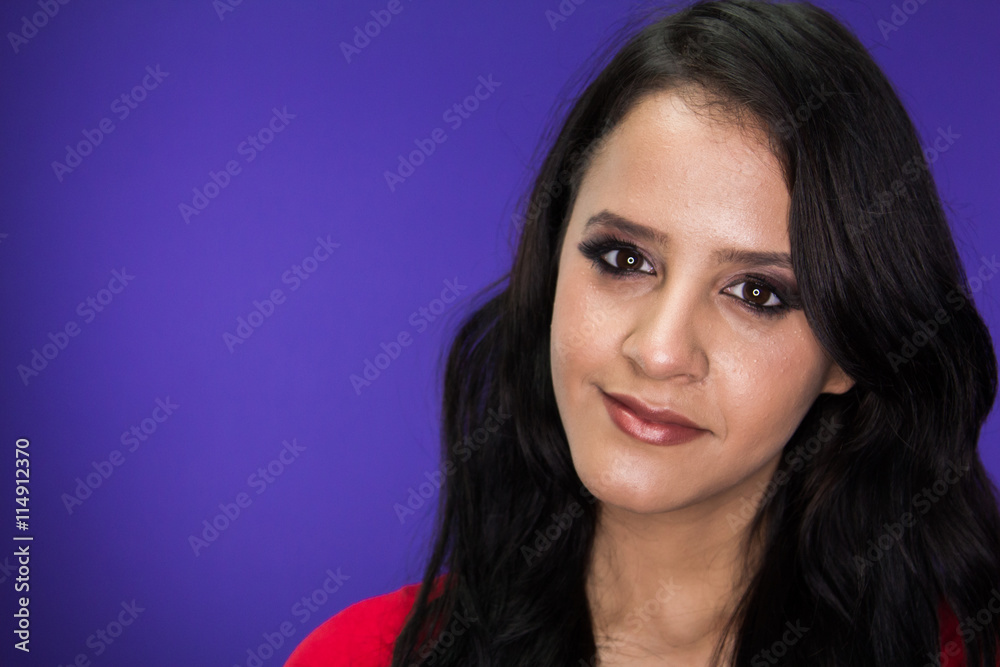 Woman looking into the camera on a purple background Woman looking into the camera on a purple background
