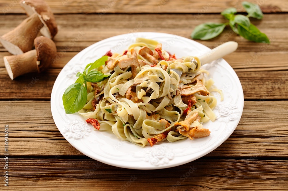 Colored pasta with wild mushrooms and basil