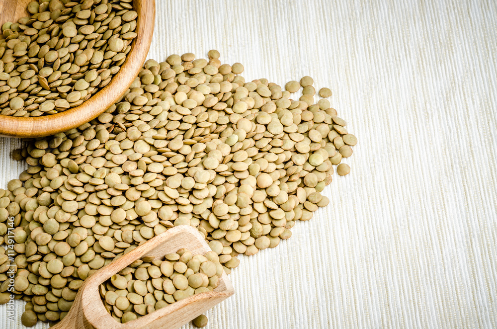 Fototapeta premium lentils, on table cloth, background, close up.