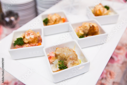 catering food in white plate on table