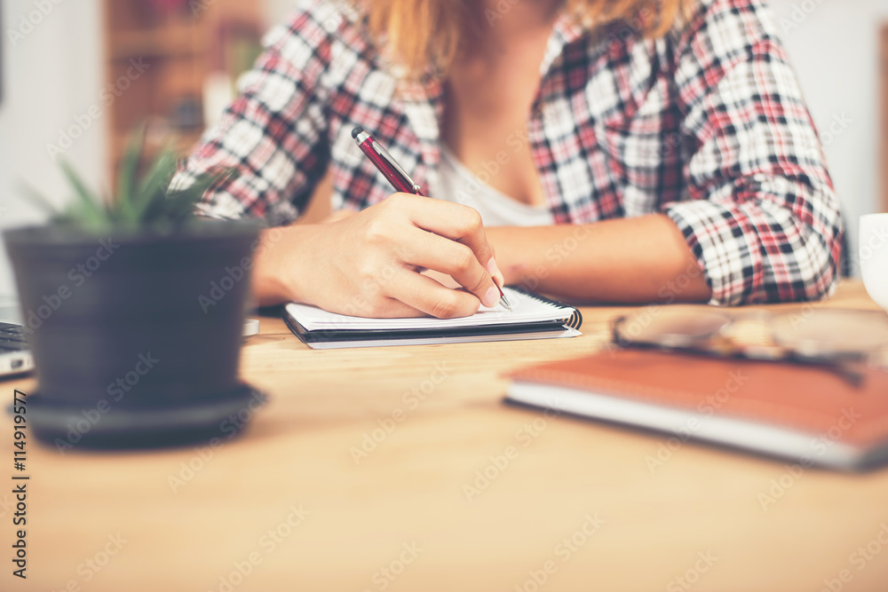 Young hipster woman writing and work in workplace. Young hipster woman writing and work in workplace.