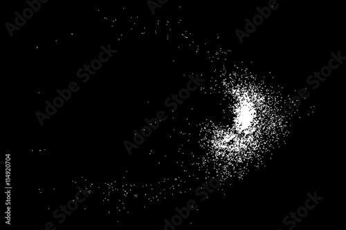 Abstract grainy texture isolated on black background. Silhouette of food flakes such as salt or almond or wheat flour spread on the flat surface or table. Top view. Dust, sand blow or bread crumbs.