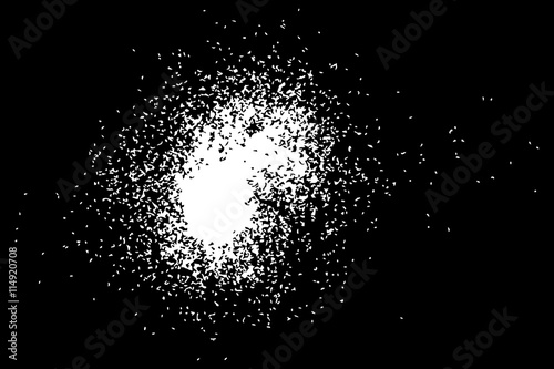 Abstract grainy texture isolated on black background. Silhouette of food flakes such as salt or almond or wheat flour spread on the flat surface or table. Top view. Dust, sand blow or bread crumbs.