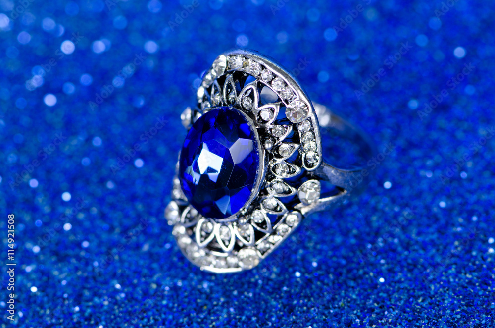 Jewellery ring against blue background Jewellery ring against blue background