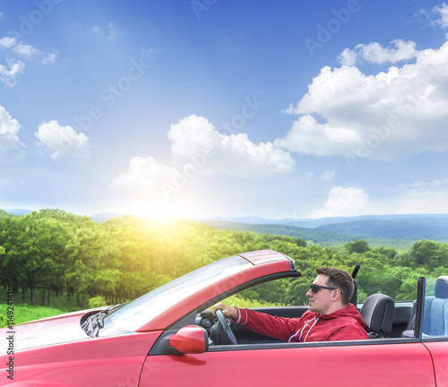 Man in convertible car.