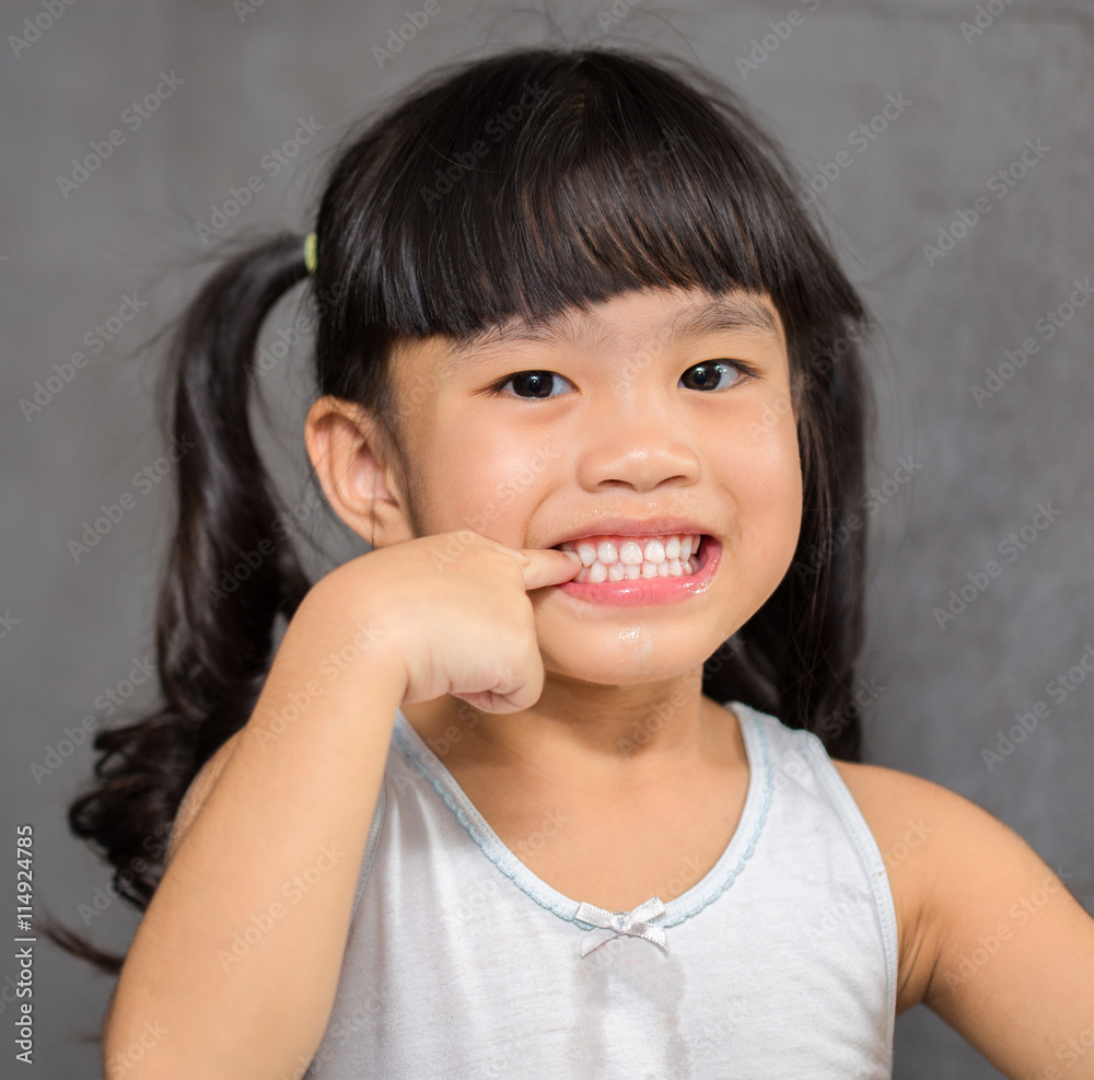 little girl pointing teeth on white After brushing teeth feeling happy little girl pointing teeth on white After brushing teeth feeling happy