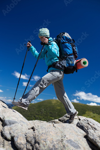 Summer hiking in the mountains with a backpack and tent.