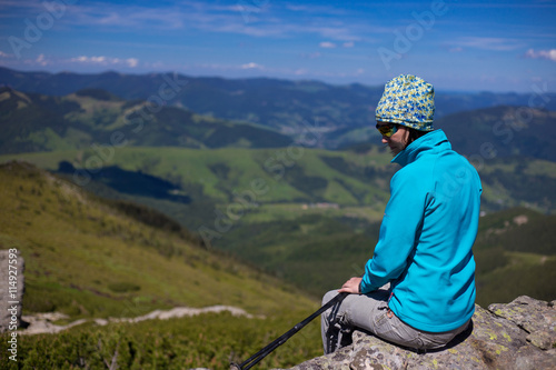 Summer hiking in the mountains with a backpack and tent.