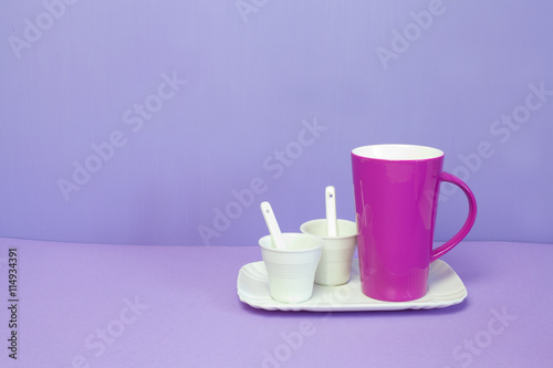 mug and coffee cup on a lilac background
