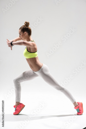 Pretty sporty girl is exercising in sportswear