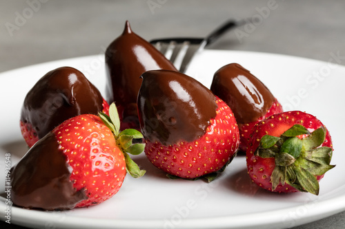 Juicy strawberry with milk chocolate photo