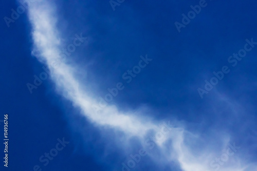 white clouds and a bright blue sky on clear day