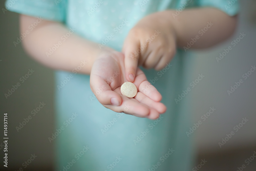medicine tablet in the hands of a child medicine tablet in the hands of a child