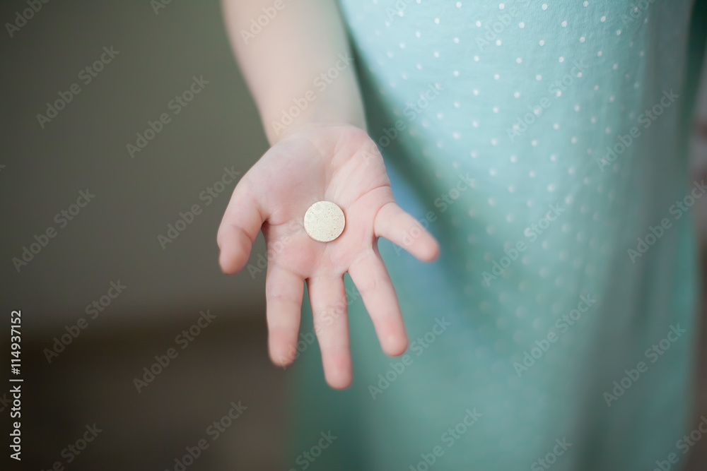 medicine tablet in the hands of a child medicine tablet in the hands of a child