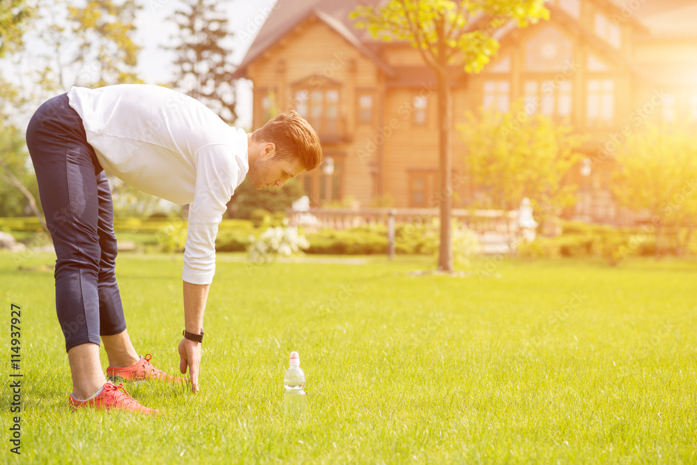 Naklejka premium Healthy male athlete doing exercise in nature