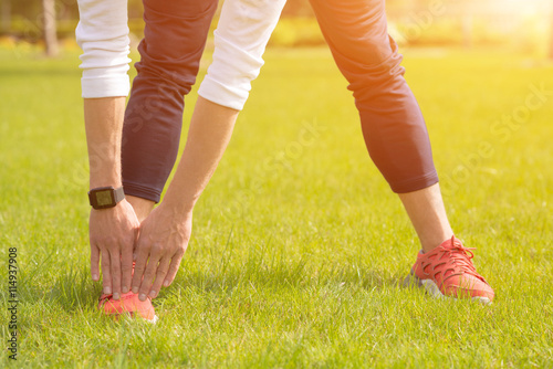 Cheerful man exercising in park