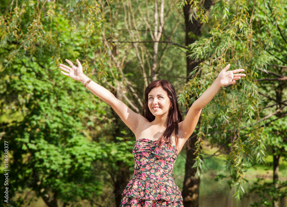 young beautiful smiling girl holds out her hands to the sky young beautiful smiling girl holds out her hands to the sky