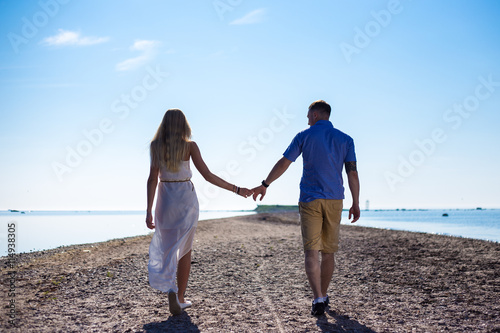 beautiful couple in love walking on the beach