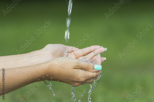 Closeup female hands under running water transparent. 