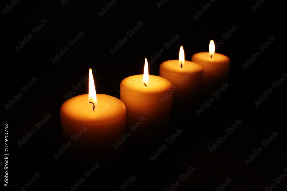 four burning candles in the dark, with space for your text four burning candles in the dark, with space for your text