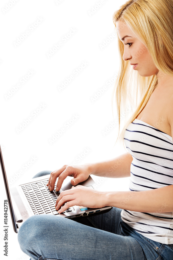 Naklejka premium Woman using laptop - isolated over a white background.