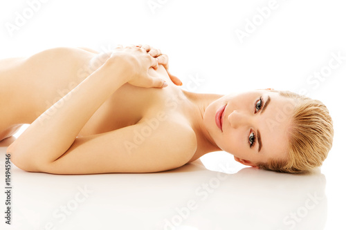 Nude woman lying on the floor