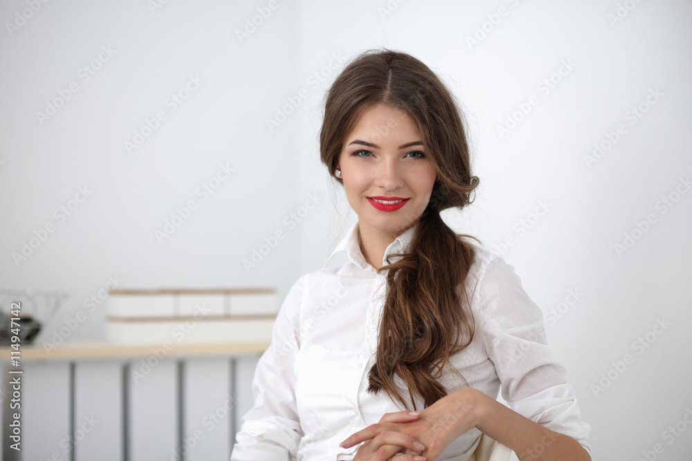 Attractive businesswoman sitting in the office Attractive businesswoman sitting in the office