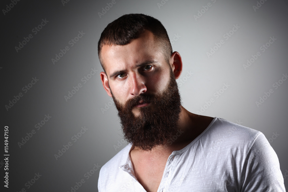 Portrait of handsome man standing, isolated on grey background