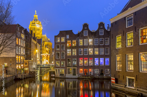 Waterfront canal houses at twilight Amsterdam