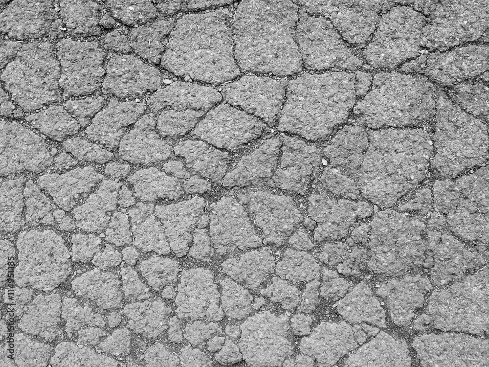 Old worn and cracked asphalt with cracks