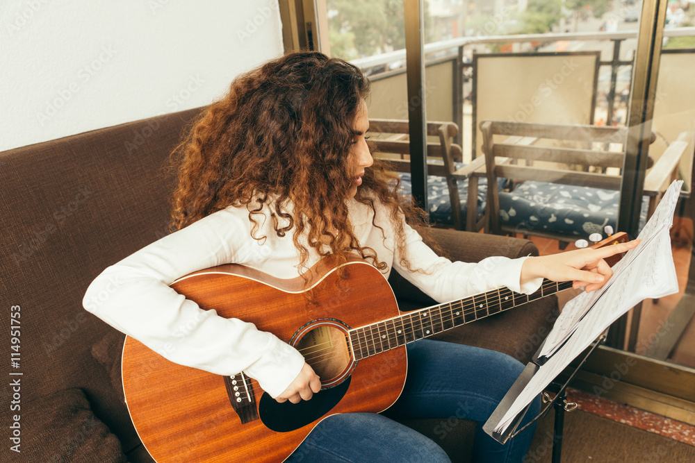 Girl playing guitar and singing. Young woman with long hair studying music  at home. She plays acoustic guitar and sing alone at home. Stock Photo |  Adobe Stock