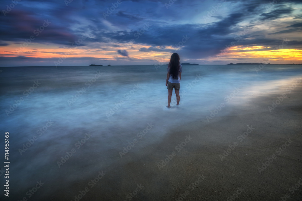 Woman stan, Turquoise sea wave at rayong Thailand. 