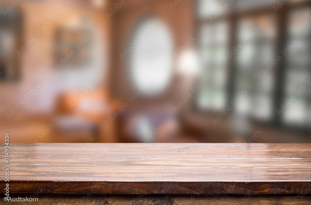 Selected focus empty brown wooden table and Coffee shop blur bac