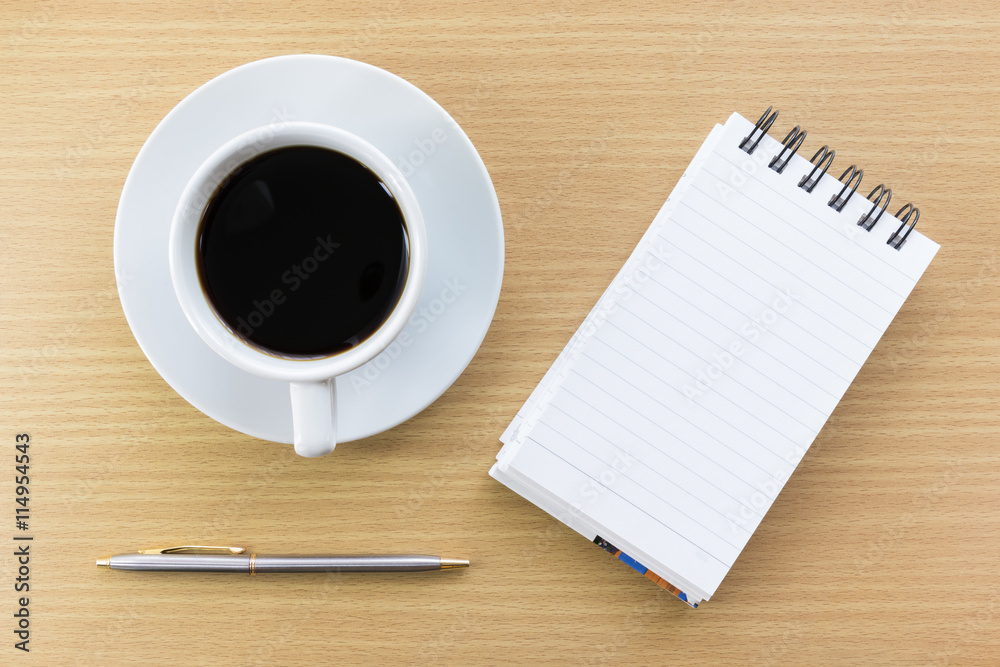 Coffee and notepad on wood table Coffee and notepad on wood table