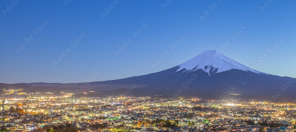 Fujiyoshida Town at night time with Mount Fuji in winter season