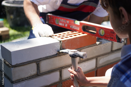 Little boy learning brick layng